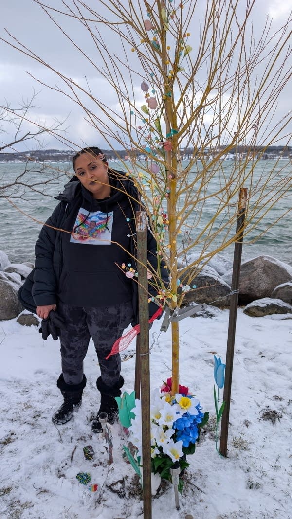 person standing next to tree