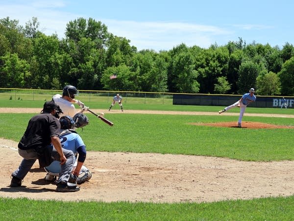 a baseball player swings a bat 