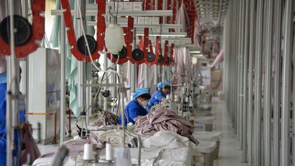 Chinese employees work on manufacturing products that will be exported to the US at a factory in Binzhou in China's eastern Shandong province on May 17, 2019. 