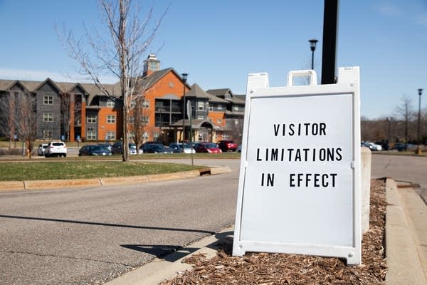 A sign warning visitors sits in front of a building.