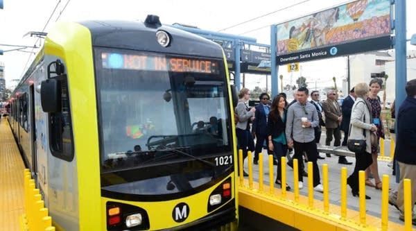 People make their way across the platform following the arrival of city, county officials and passengers on the first train in 53 years to arrive at Santa Monica station in California on May 20. The extension connects the Expo Line from its current end location near Venice and Robertson boulevards to downtown Santa Monica.