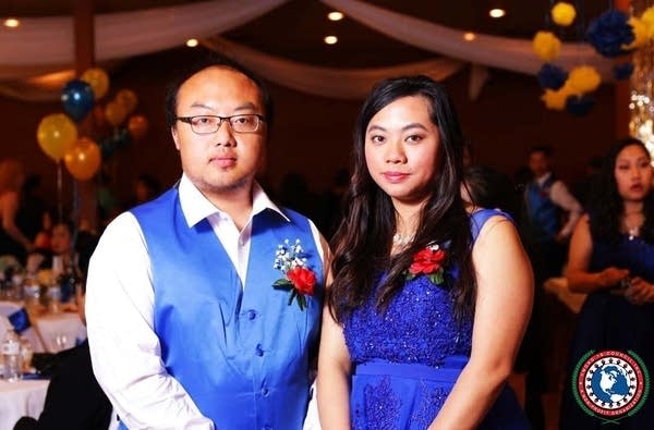 Two people wearing blue smile for the camera 