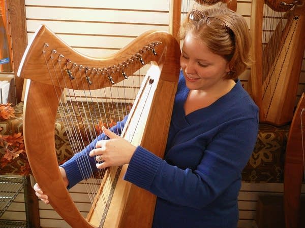 A woman plays a Celtic harp