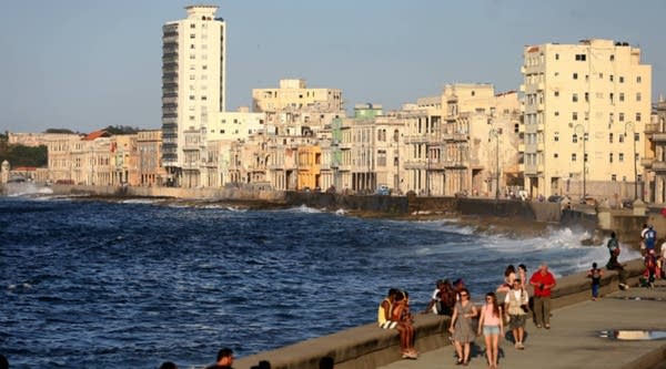 People walk along the Malecon — an esplanade — in Havana, Cuba . On today's show, we'll talk about President Obama's reported upcoming trip to Cuba.