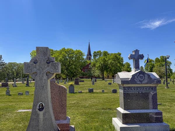 The steeple of St. Anthony Catholic Church rises above 