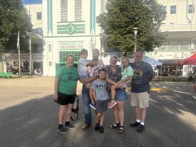 Parent and children pose in front of a building 