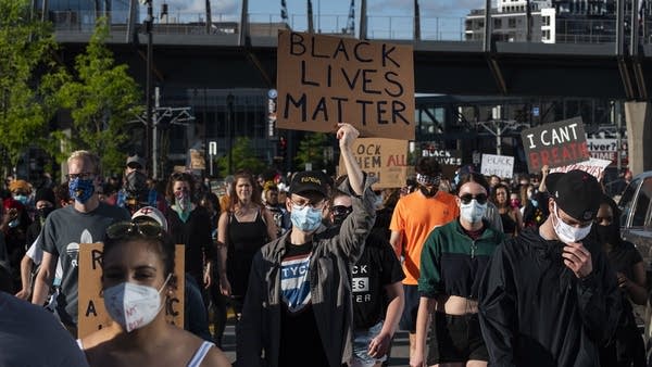 Protesters march by U.S. Bank Stadium in response to the police killing of George Floyd on May 29, 2020 in Minneapolis, Minnesota.