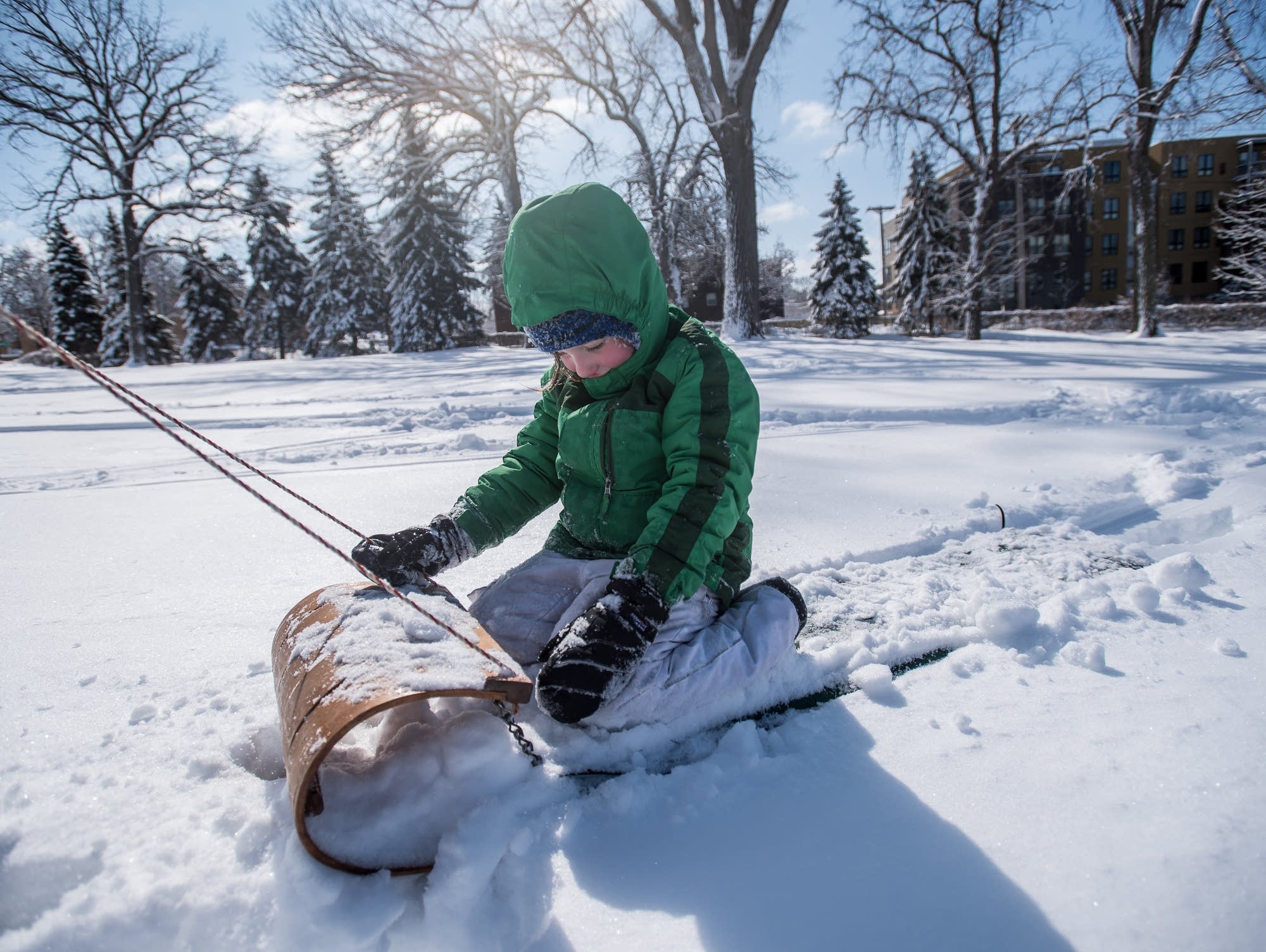 Annie Knapp gets a tow on her toboggan