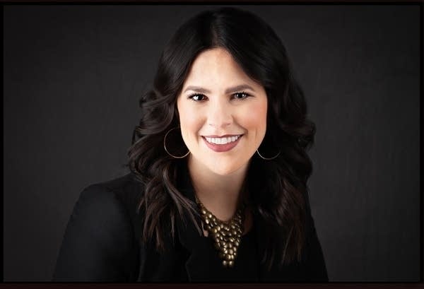 A professional headshot of a woman.
