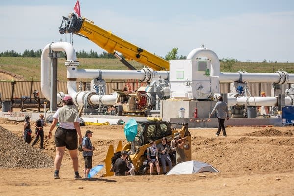 People walk around a construction site.