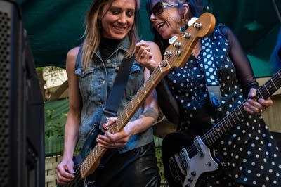 a rock band performing on an outdoor stage