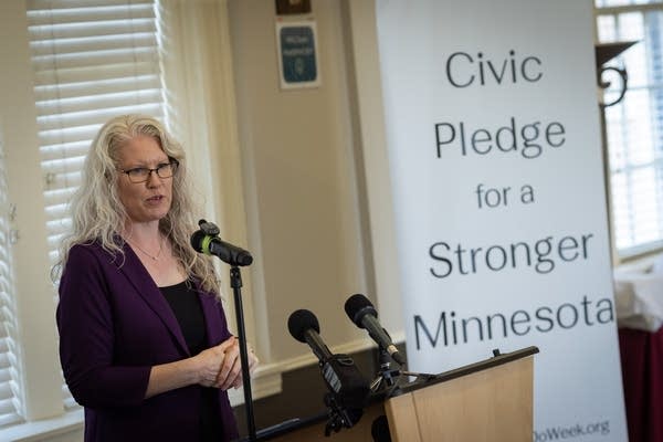 A woman speaks at a podium
