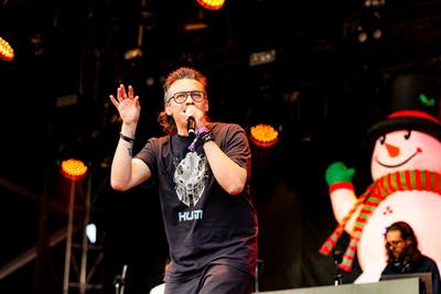 Slug of Atmosphere performs on an outdoor stage.