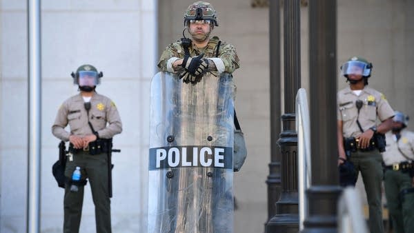 Los Angeles Mayor Eric Garcetti says his city cut $100 million to $150 million from the police department.