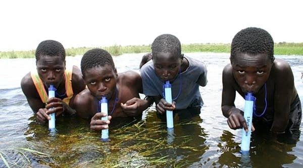 Boys drink through Lifestraws