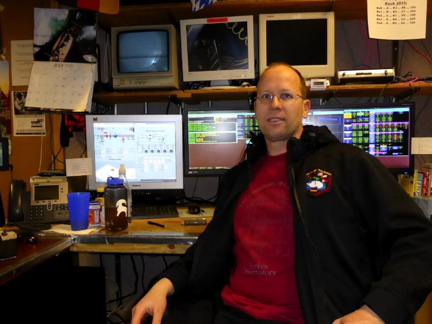 Robert Schwarz sits in front of the controls to the Keck Array.