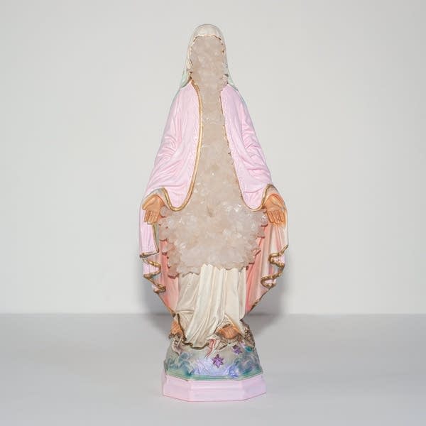 A saint statue adorned in crystals