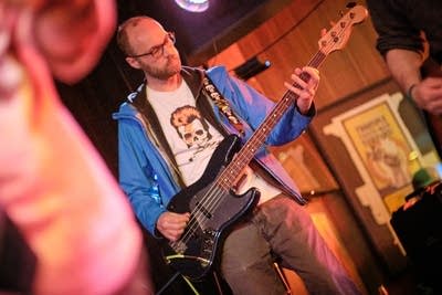 A musician plays bass onstage