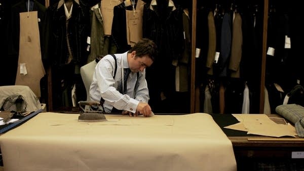 A cutter marks out a pattern at Huntsman tailors in London, England. According to menswear writer Derek Guy, fewer and fewer tailors understand the lost art of “ironwork” in the construction of pants. 