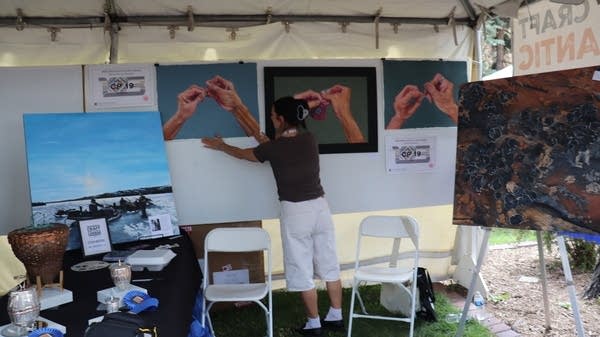 Inuit painter Jessica Winters with her works.