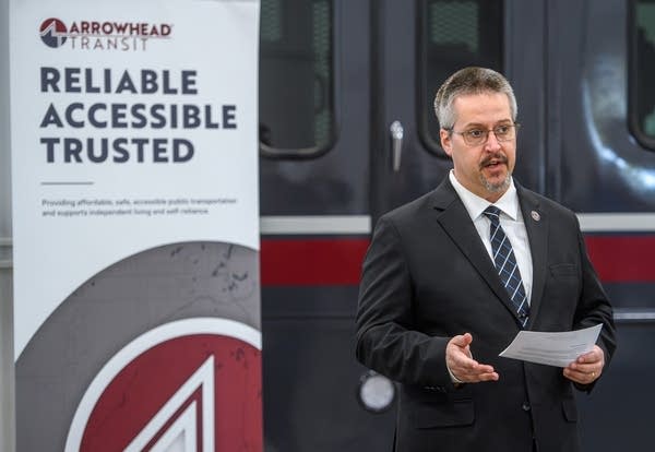 man talking in front of train 