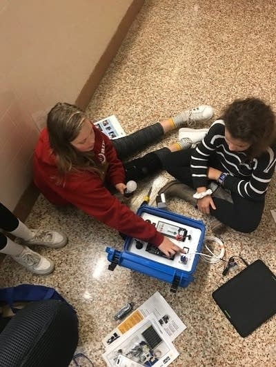 Students at St. Louis Park Middle School assemble a solar suitcase.