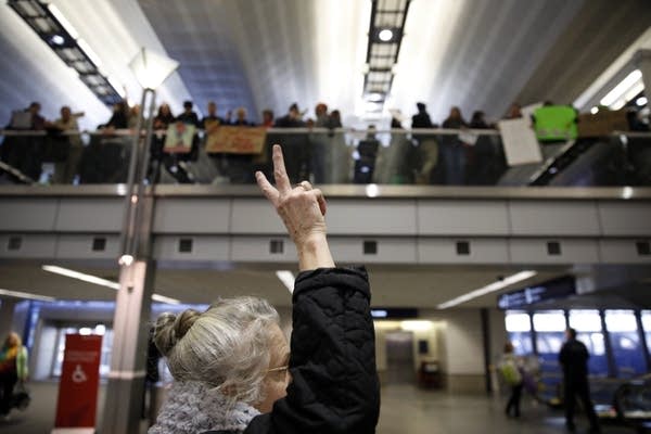 Travelers show signs of support for the protesters during a rally.