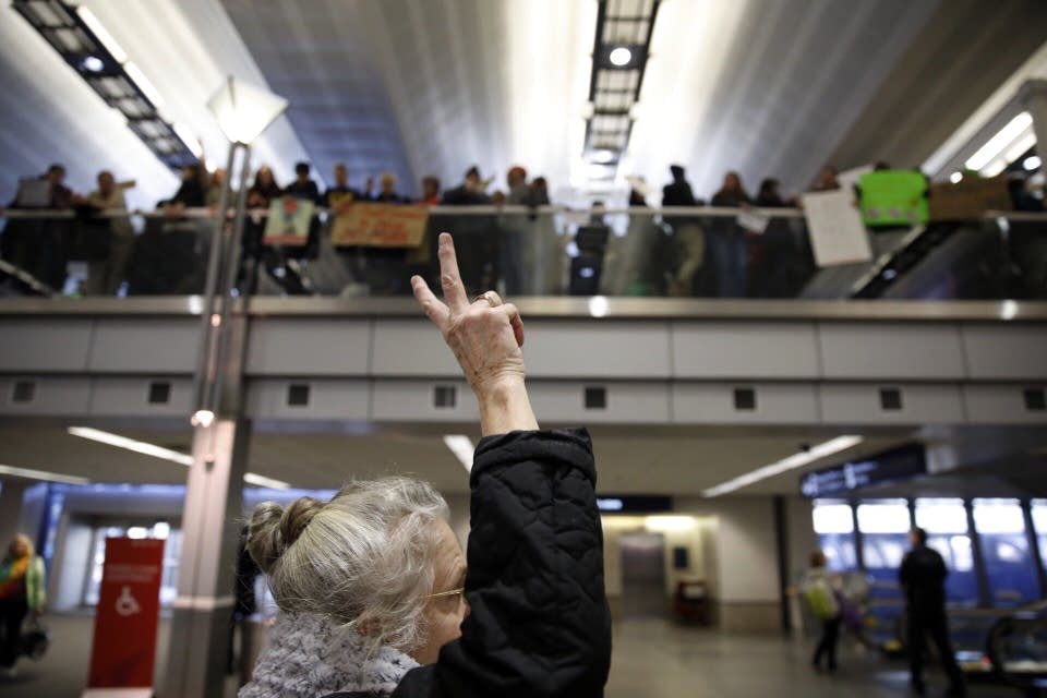 Travelers show signs of support for the protesters during a rally.