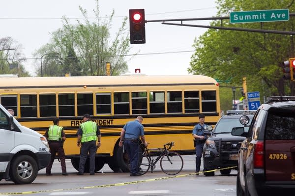 St. Paul police remove the bike of a man killed in a collision with a bus.