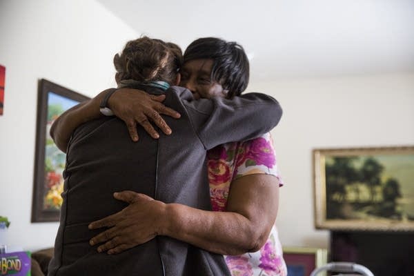 Rosalyn Cole hugs Judy Jones after receiving her Meals on Wheels delivery.