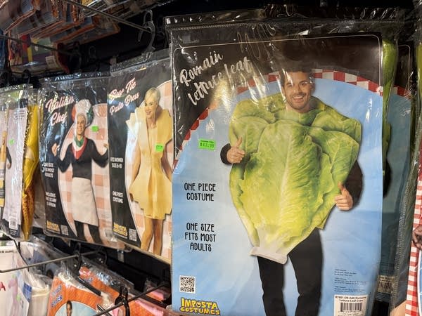 A packaged costume of a head of lettuce is seen in a costume shop.