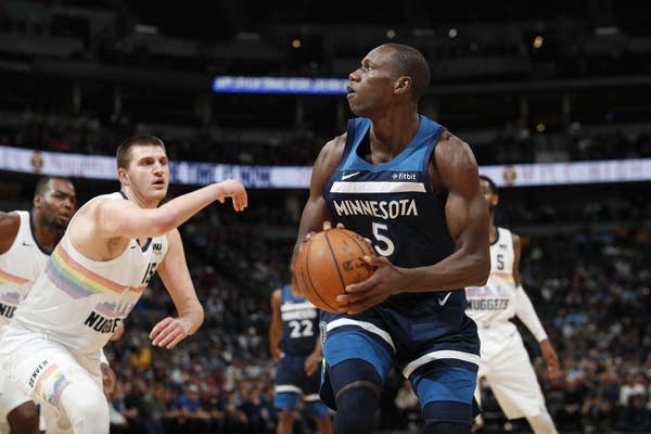 Two men playing basketball