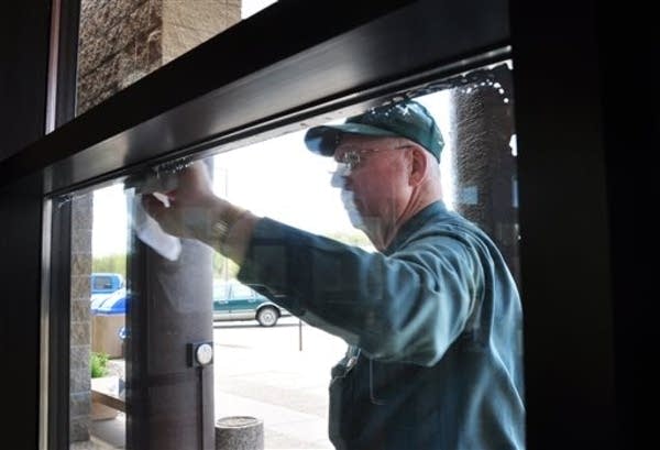Norm Greenwaldt washes windows