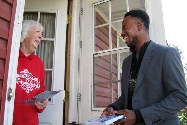 Mike Elliott talks with voter Nancy Tanji.