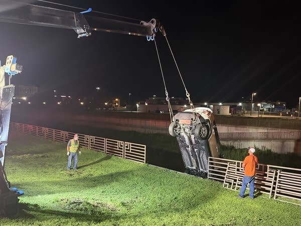 Crews remove a vehicle from a river following a crash