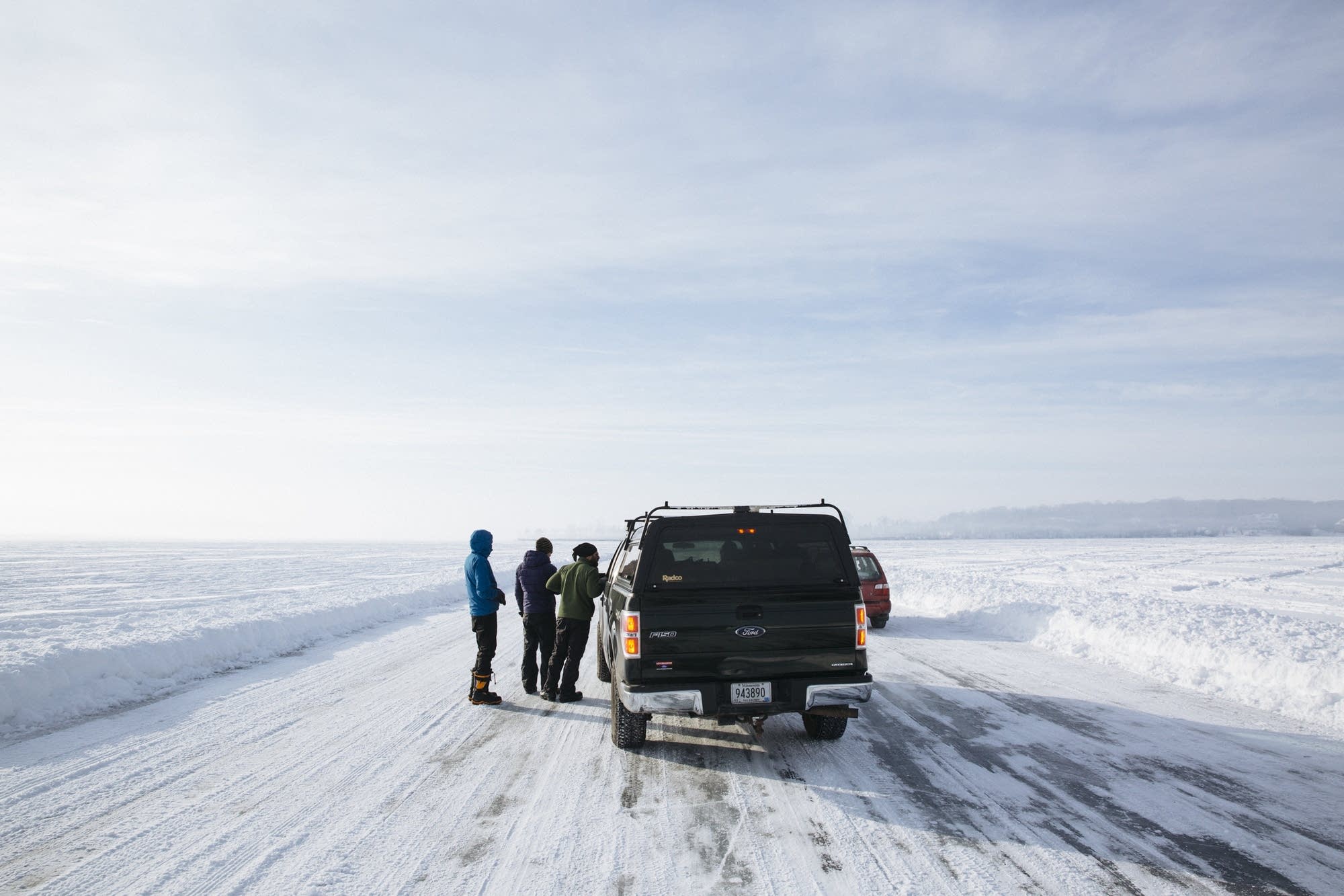 Researchers cross the frozen surface of Lake Minnetonka