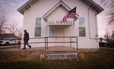 A man walks outside of the Vasa Town Hall building.