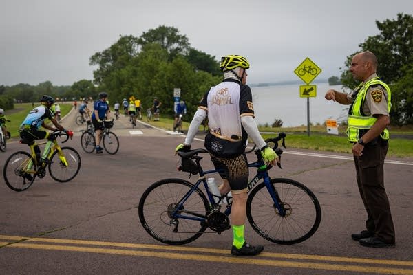 A sheriff gives instructions to a cyclist