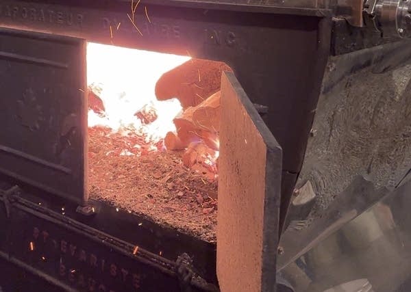 The inside of the wood furnace in the sugar house burns so hot that the Cermaks toss a couple dozen logs inside every five minutes.