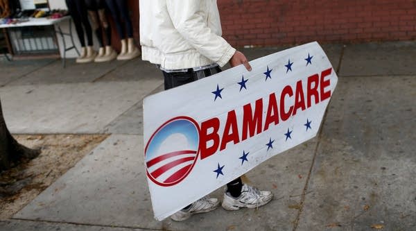 A sign directing people to an insurance company where they can sign up for the Affordable Care Act, a component of which, called the "Cadillac tax," is coming under fire. 