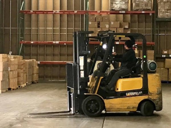 A worker about to move stock at the Medsource Labs warehouse in Chaska, Minn.