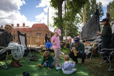 People sit back stage