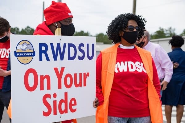 Amazon workers hold up pro-union signs outside the company's warehouse in Bessemer, Alabama.
