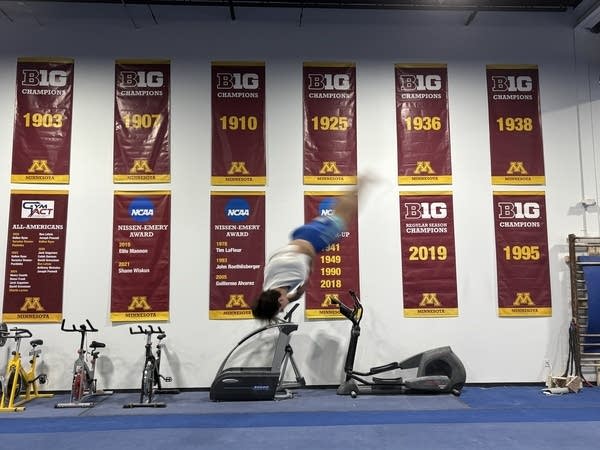 A gymnast flips in the air