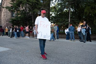 A person holds a protest sign