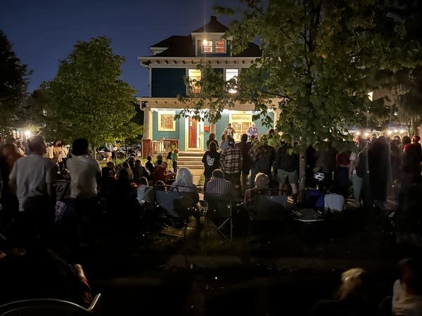 A person performs on a porch
