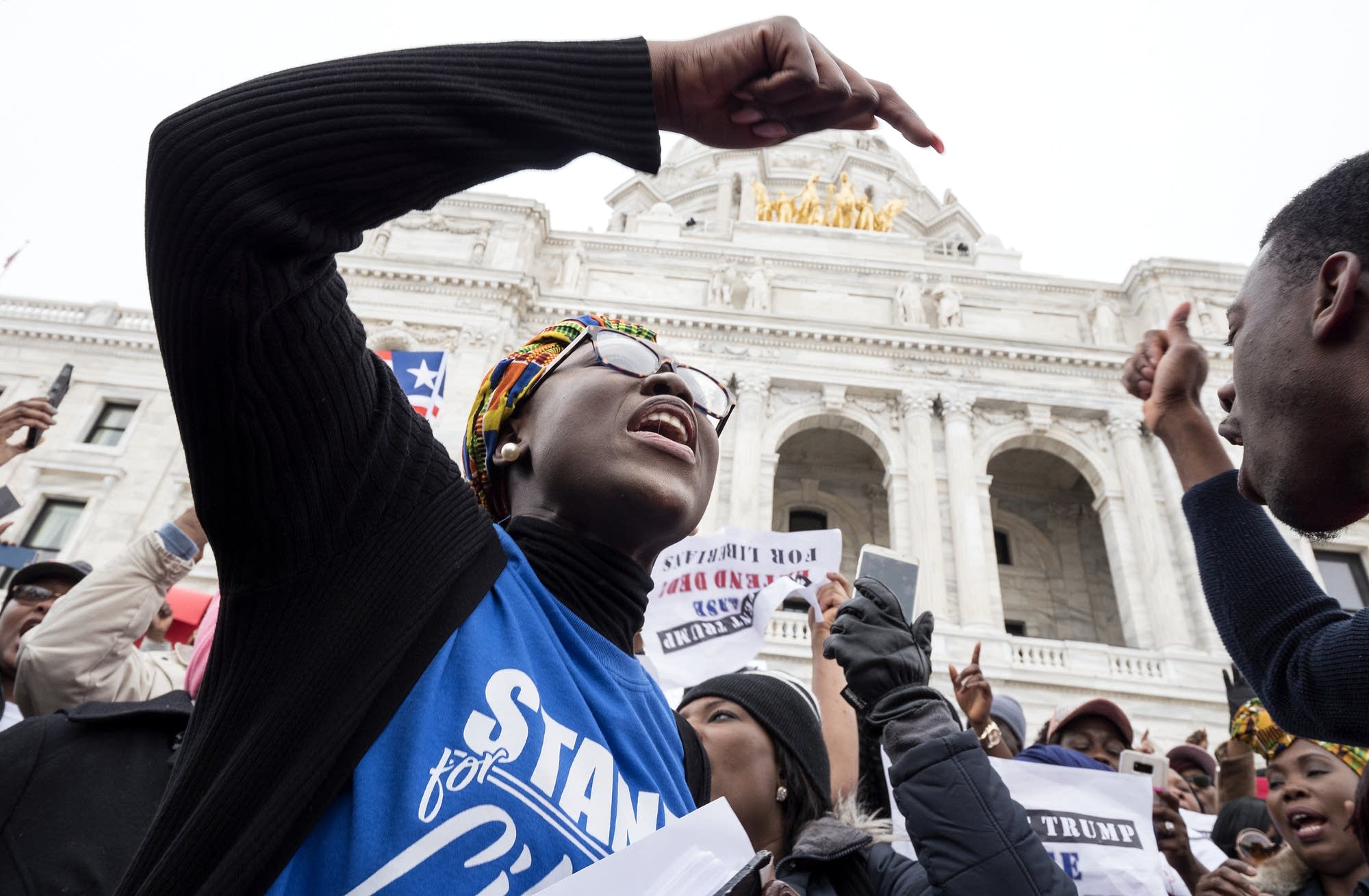 Organizer Fata Acquoi, right, sings with attendees at a rally.