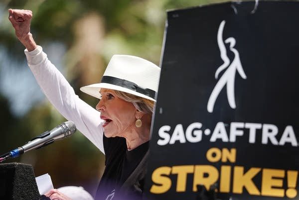 LOS ANGELES, CALIFORNIA - JULY 28: Jane Fonda speaks to the crowd as Starbucks workers stand on the picket line with striking SAG-AFTRA and Writers Guild of America (WGA) members in solidarity outside Netflix studios on July 28, 2023 in Los Angeles, California. The show of support is part of a Starbucks Workers United ‘The Union is Calling’ summer bus tour across 13 cities in an effort to unionize more Starbucks stores with workers calling for a living wage and other protections amid a so-called ‘hot labor summer’. 