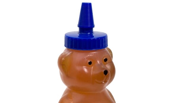 Plastic honey bottle shaped like a bear -- closeup on the face