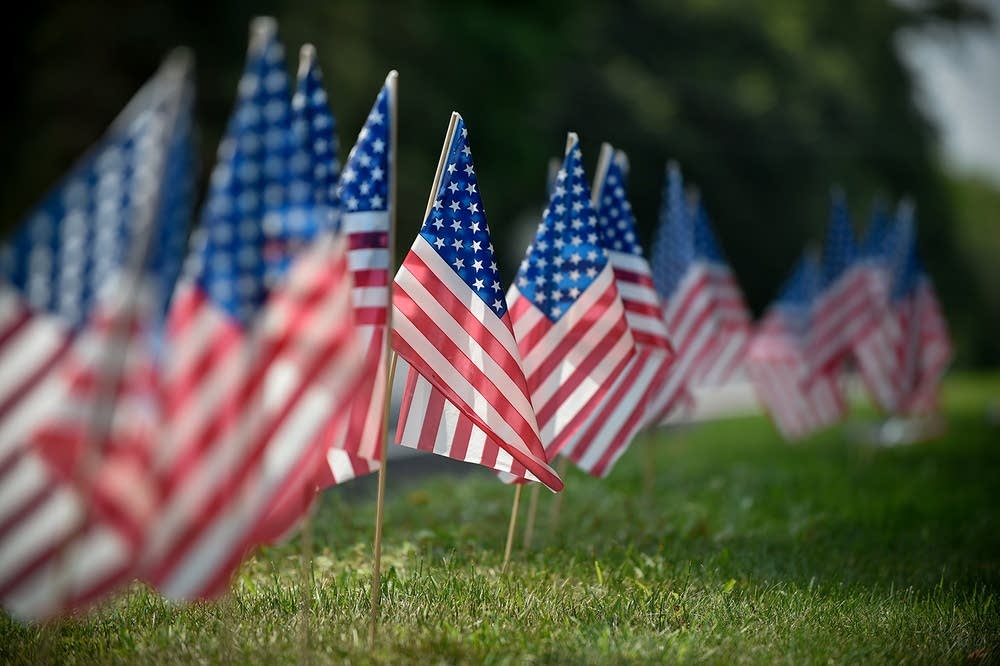 Flags line the funeral procession route